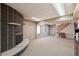 Basement with a brick fireplace, carpeted floor, and stairs leading to the upper level at 3261 Kassler Pl, Westminster, CO 80031