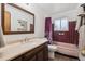 Functional bathroom showcasing a tile accent wall, a pink bathtub, and a modern vanity at 3261 Kassler Pl, Westminster, CO 80031