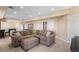 Open basement area with large sectional sofa, ottoman, pool table, and neutral carpet at 26861 E Clifton Dr, Aurora, CO 80016