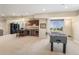 Basement with a game area, foosball table, bar with counter seating, and natural light at 26861 E Clifton Dr, Aurora, CO 80016