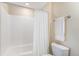Bright bathroom featuring a shower-tub with white tile, a white shower curtain, and a toilet at 26861 E Clifton Dr, Aurora, CO 80016