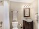 Well-lit bathroom with vanity sink, framed mirror, shower/tub with white curtain and toilet at 26861 E Clifton Dr, Aurora, CO 80016