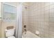 Cozy bathroom with tiled shower-tub, window, and toilet with neutral wall color at 26861 E Clifton Dr, Aurora, CO 80016
