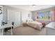 Serene bedroom with neutral tones, a cozy bed, and a view of the neighborhood at 26861 E Clifton Dr, Aurora, CO 80016
