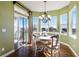 Cozy breakfast nook with bright windows, hardwood floors, and an elegant chandelier at 26861 E Clifton Dr, Aurora, CO 80016