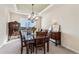 Formal dining room featuring elegant furnishings, tray ceiling, and plenty of natural light at 26861 E Clifton Dr, Aurora, CO 80016