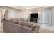 Spacious living room with plush sectional couch, television, and multiple entryways at 26861 E Clifton Dr, Aurora, CO 80016