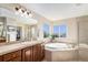 This spacious main bathroom features a jacuzzi tub, shower and walk in closet at 26861 E Clifton Dr, Aurora, CO 80016