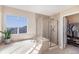 This main bathroom features a relaxing soaking tub, glass enclosed shower and walk in closet at 26861 E Clifton Dr, Aurora, CO 80016
