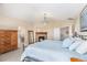 Spacious main bedroom featuring a cozy fireplace, a large bed, and an ensuite bathroom at 26861 E Clifton Dr, Aurora, CO 80016