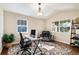 Well-lit office space with hardwood floors, large windows, and a comfortable seating area at 26861 E Clifton Dr, Aurora, CO 80016