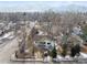 An aerial view of a quaint home with mature trees and mountain views in a quiet neighborhood at 2024 Ford St, Golden, CO 80401