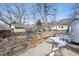 Large backyard with mature trees, landscaping, and a variety of features; including a garden area and a silver Airstream trailer at 2024 Ford St, Golden, CO 80401