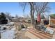 Backyard with patio featuring an outdoor dining set, mature shade tree, and an abundance of plantings at 2024 Ford St, Golden, CO 80401