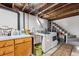 Basement laundry area featuring a washer and dryer, utility sink, and exposed ceiling beams at 2024 Ford St, Golden, CO 80401