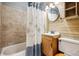 Cozy bathroom featuring stylish tile walls, wood accents, and a shower with curtains at 2024 Ford St, Golden, CO 80401