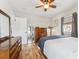 Bright bedroom features hardwood floors, a ceiling fan, and windows with gray curtains at 2024 Ford St, Golden, CO 80401