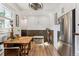 Charming dining area featuring a rustic table, white walls, and a stainless steel refrigerator at 2024 Ford St, Golden, CO 80401