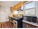 Compact kitchen with stainless steel appliances and bright natural light from a window at 2024 Ford St, Golden, CO 80401