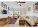 Well-lit living room boasting hardwood floors, a modern ceiling fan, and comfortable furnishings at 2024 Ford St, Golden, CO 80401