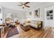 Sunlit living room showcasing hardwood floors, a cozy seating arrangement, and a view of the outdoors at 2024 Ford St, Golden, CO 80401