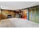 Basement features a stone accent wall with a fireplace and a built-in wet bar at 370 S Parfet St, Lakewood, CO 80226