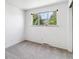 A carpeted bedroom with neutral walls, a large window, and neutral colors at 370 S Parfet St, Lakewood, CO 80226