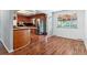 Open concept eat-in kitchen with wood cabinets, stainless steel appliances, and hardwood floors at 370 S Parfet St, Lakewood, CO 80226