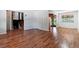 A spacious living room with hardwood floors adjacent to the kitchen and a staircase at 370 S Parfet St, Lakewood, CO 80226