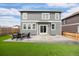 Exterior rear view showcasing a backyard with patio, furniture set, and turf at 14100 Shasta Daisy St, Parker, CO 80134