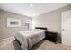 Bedroom featuring a queen-size bed with neutral linens, carpeted floors, natural light, and modern decor at 14100 Shasta Daisy St, Parker, CO 80134