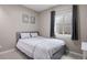 Bedroom with a queen-sized bed, carpeted floors, modern decor, and a window providing natural light at 14100 Shasta Daisy St, Parker, CO 80134