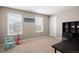 Bright bedroom featuring two windows with blinds, carpeted floors, a desk, and neutral decor at 14100 Shasta Daisy St, Parker, CO 80134