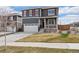 Charming two-story home with red accents, a well-manicured lawn, and an attached two car garage at 14100 Shasta Daisy St, Parker, CO 80134