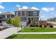Charming two-story home features a well-manicured lawn, red shutters, and a welcoming front porch at 14100 Shasta Daisy St, Parker, CO 80134