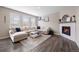 Inviting living room features a fireplace, large windows, and a plush sectional sofa with stylish decor at 14100 Shasta Daisy St, Parker, CO 80134