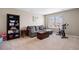Spacious living room with carpet, a comfortable couch, bookshelf, and plenty of natural light from the large window at 14100 Shasta Daisy St, Parker, CO 80134