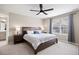 Tranquil main bedroom boasts a ceiling fan, bedside tables with lamps, and window with shades at 14100 Shasta Daisy St, Parker, CO 80134