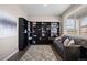 Cozy home office features built-in bookshelves, a comfortable couch, and large window with natural light at 14100 Shasta Daisy St, Parker, CO 80134