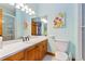 Bathroom with wood cabinets, tiled countertop, and a glass-enclosed shower at 22554 Treetop Ln, Golden, CO 80401