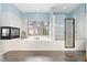 Modern bathroom with a freestanding tub, glass block shower, a fireplace and beautiful tile flooring at 22554 Treetop Ln, Golden, CO 80401