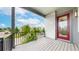 A bright balcony offers a view of the street and neighboring houses with a red door at 6799 Navajo St, Denver, CO 80221