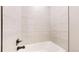 A bright bathroom features a tiled shower and tub with modern fixtures at 6799 Navajo St, Denver, CO 80221