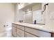 Bathroom features double sinks, modern fixtures, a large mirror and a walk-in shower at 6799 Navajo St, Denver, CO 80221