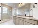 Bathroom features double sinks, modern fixtures, large mirror, and walk-in shower with bench at 6799 Navajo St, Denver, CO 80221