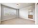 Bedroom boasts a large window, neutral carpet, and an opening to the ensuite bathroom at 6799 Navajo St, Denver, CO 80221