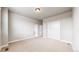 Spacious bedroom with neutral carpet, white trim, large window, and closet with sliding doors at 6799 Navajo St, Denver, CO 80221