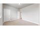 A bright bedroom features neutral paint, carpet, white trim, and two doors at 6799 Navajo St, Denver, CO 80221