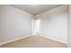 A bright bedroom features neutral paint, carpet, white trim, and an open doorway at 6799 Navajo St, Denver, CO 80221