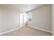 A neutral bedroom has a window, carpet and white trim and neutral paint at 6799 Navajo St, Denver, CO 80221